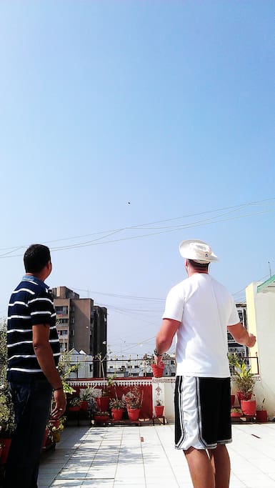 A guest indulging in kite flying on the terrace