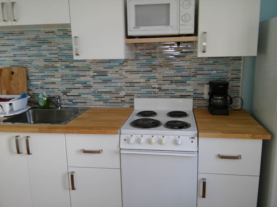 Butcher block counter, new cabinets and tile back splash