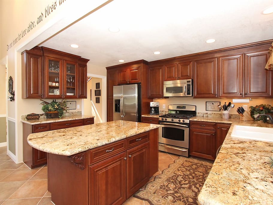 Kitchen island with a wonderful blend of wood, stone, and stainless.