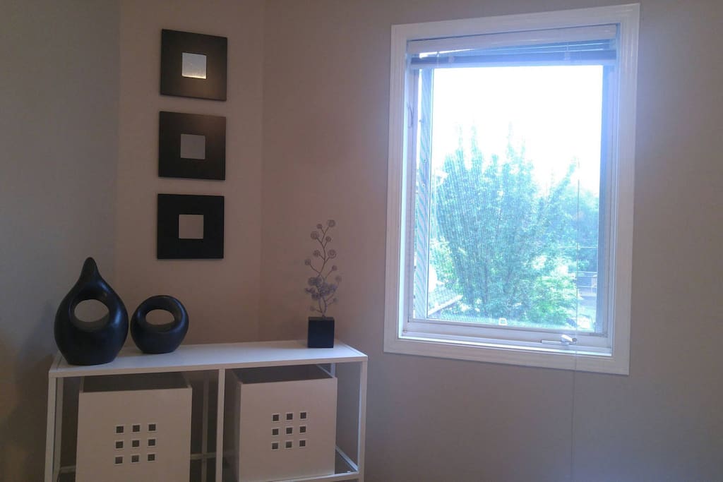 Bedroom - bright window and convenient shelving with storage
