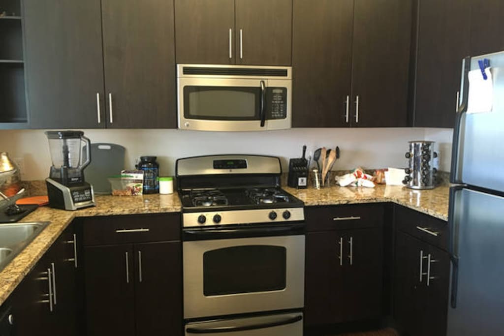 Granite Counter Tops in the Kitchen with Full Size Stainless Steel Appliances, Ice Maker in Freezer, Blender, Spice Rack you can use to make Food, just put it back afterwards