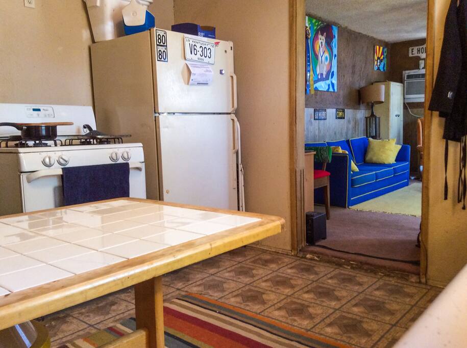 Tiny Kitchen with full range gas stove, fridge and small table