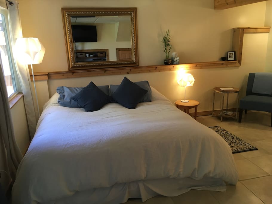 King-sized sleep number bed with memory foam topper and down comforter.