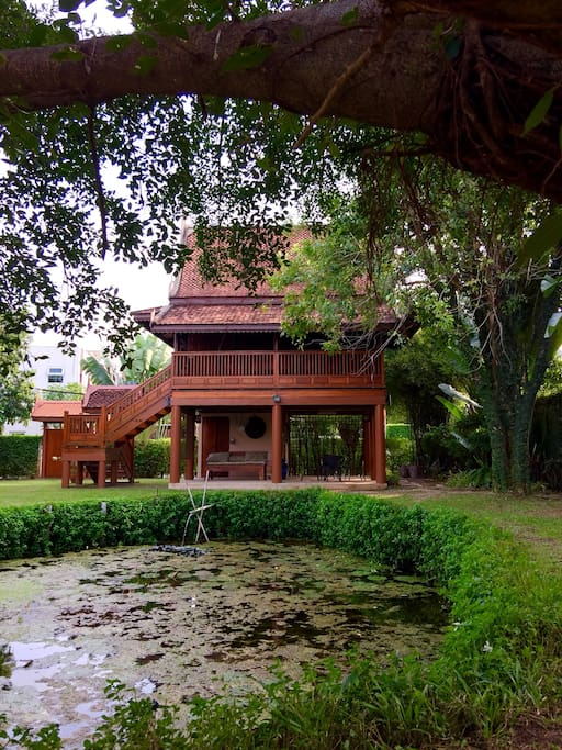 Exterior of the house facing the garden and pond.