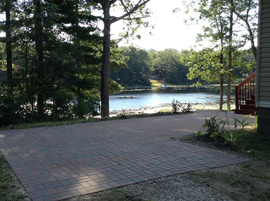 Guests enjoy the serenity of the lake from the patio or main deck. Ample seating options are available.