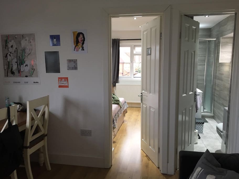 Dining table and entrance to independent bathroom and bedroom