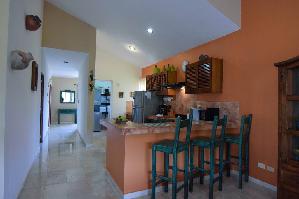 fully equipped open kitchen with breakfast bar