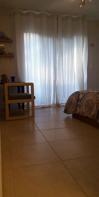 curtained sliding glass doors leading to patio