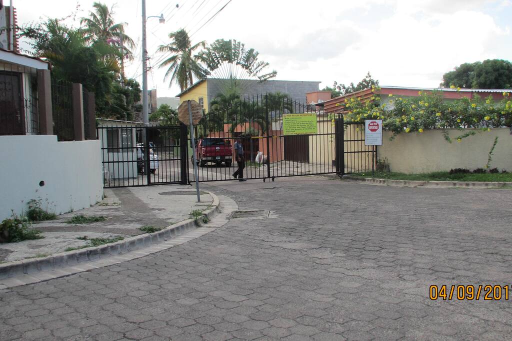 Entrada Principal de la 1a. calle con Portón y guardia de seguridad privada.