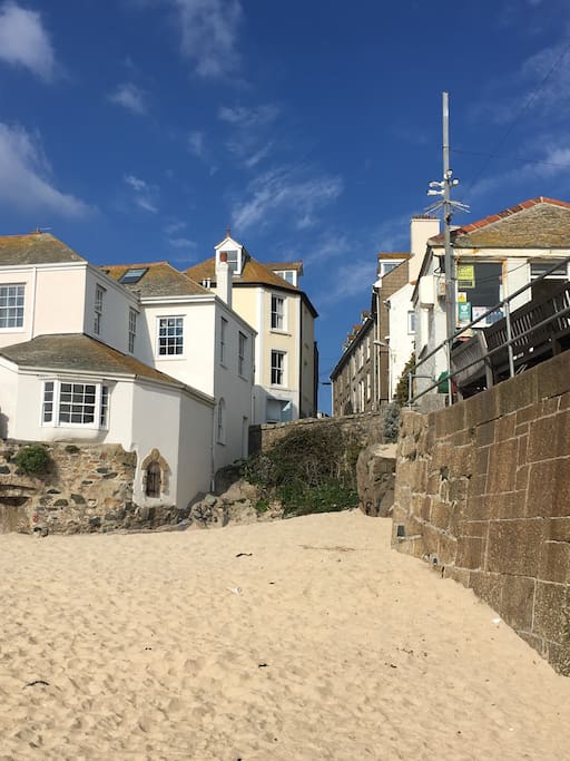 View of Pier House from the lovely south facing and sheltered harbour beach. A real safe little haven for the little ones or grown ups alike