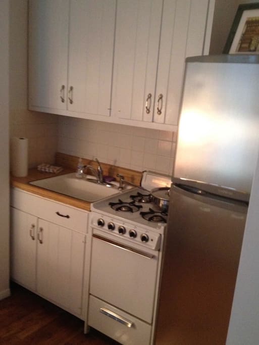 Kitchen: cabinets, sink, stove, refrigerator