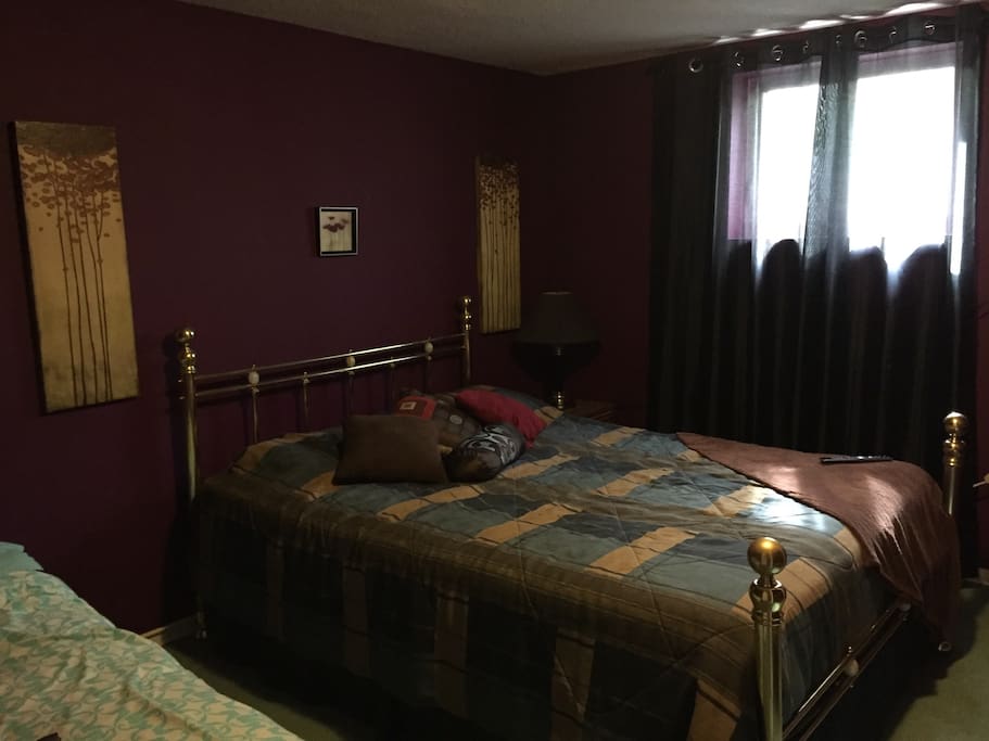 Spacious bedroom with full closet. One queen and one double bed. This room also has a TV with Cable service.