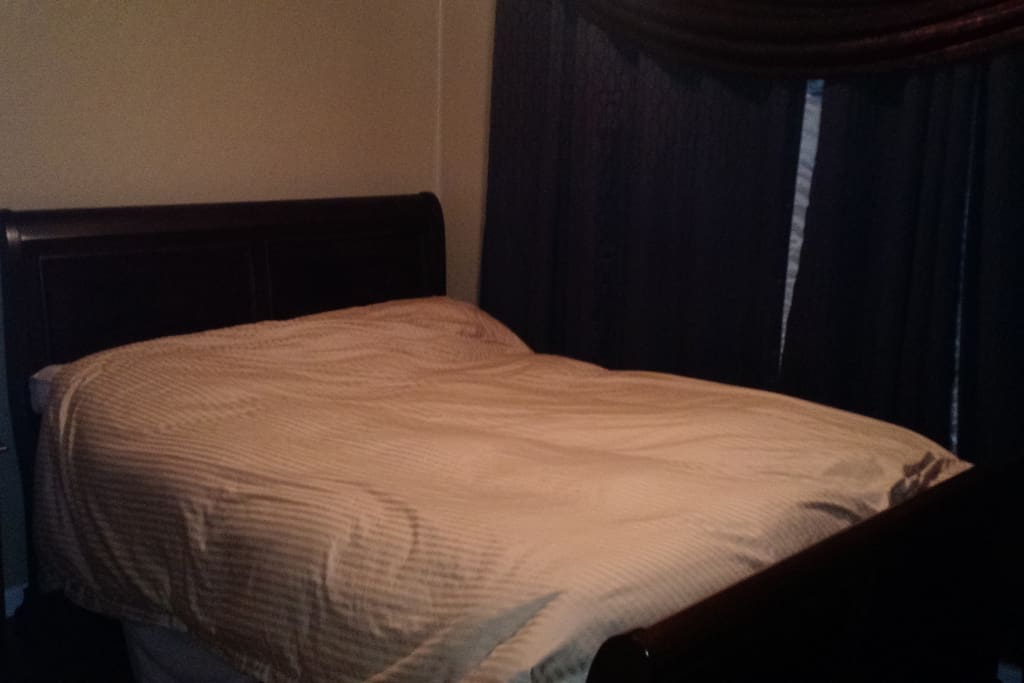 Tempurpedic mattress with real down comforter and full blackout drapes and blinds (which open for sunlight when desired)