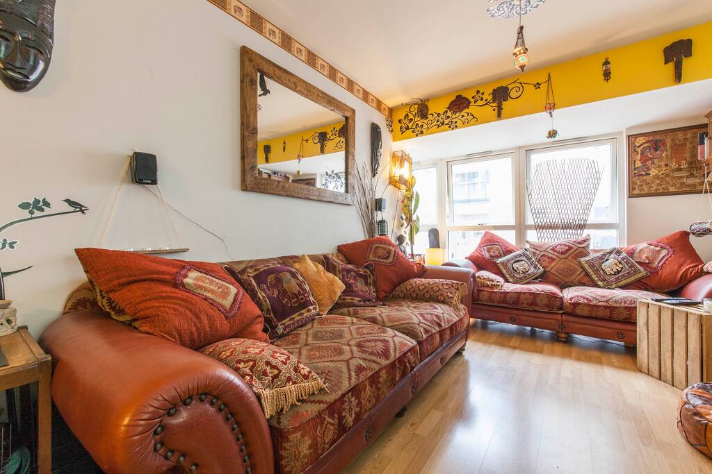 Ethnic infusion designed home - giving it some character! Most flats are neutral and have no COLOUR! These duck- feather sofas are the comfiest in the world! They are 1 metre DEEP! This basically means two people can comfortable lounge in it! Beware: you won't want to get out of it though! They're addictive!