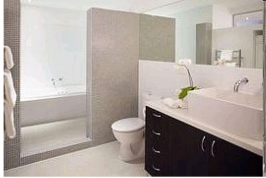 Spacious bathroom with shower, spa bath and plenty of cupboard space