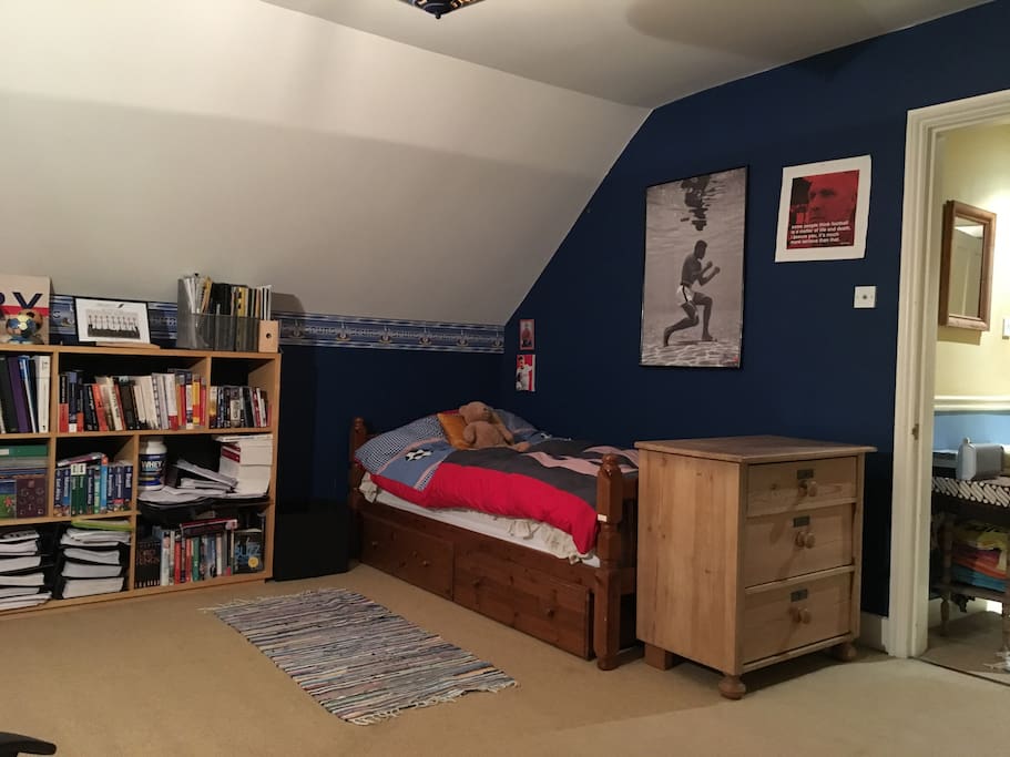 Single bed, at the other end of the room.