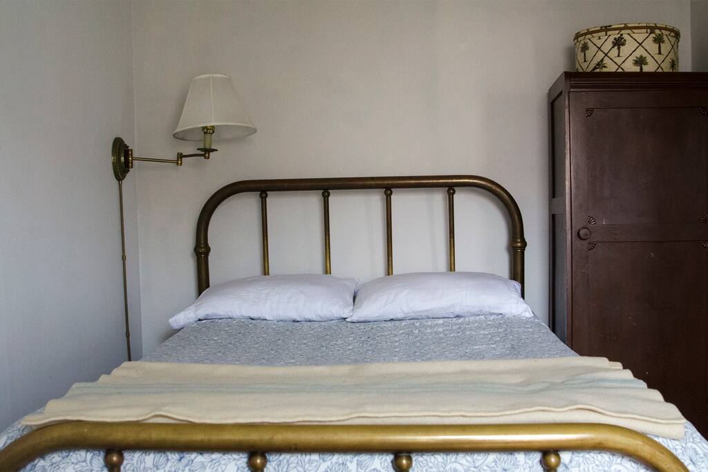 Full size brass bed with pillow top mattress. During the colder months there is a down-filled comforter on the bed.