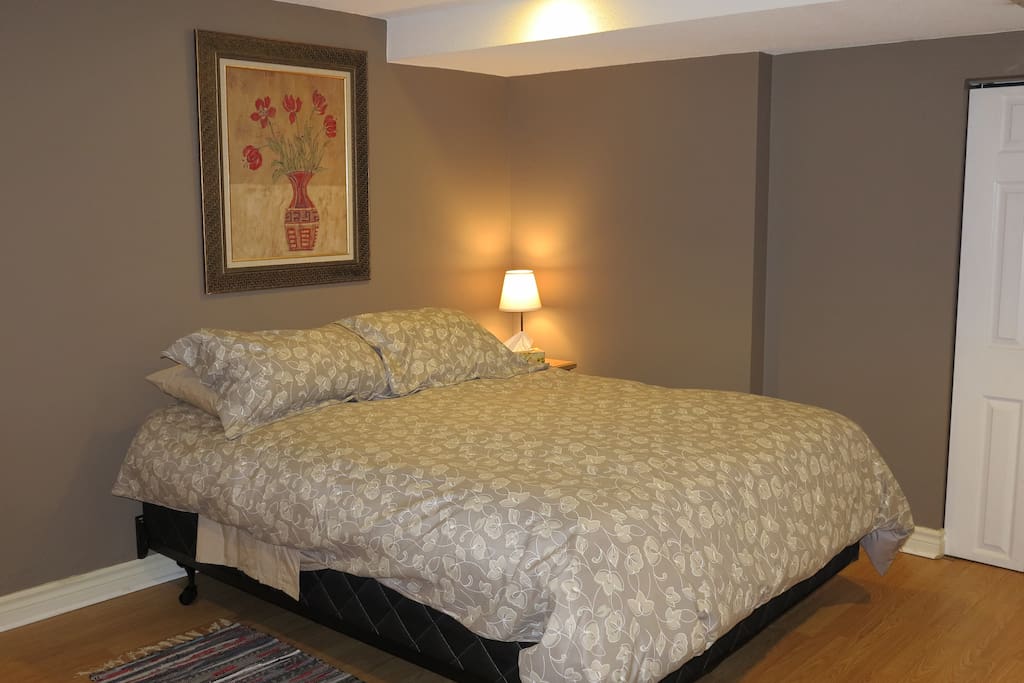Queen bed in large bedroom