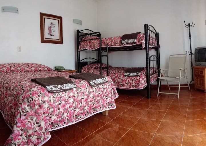 Spacious and cool room, with double bed and 2 bunk beds, has its private bathroom, with access to a balcony through large windows that also have mosquito nets and has a ceiling fan 