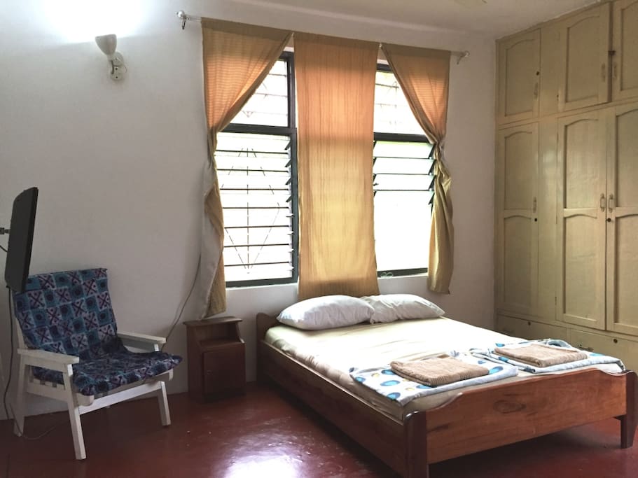 The room with bed, chair, cabinet