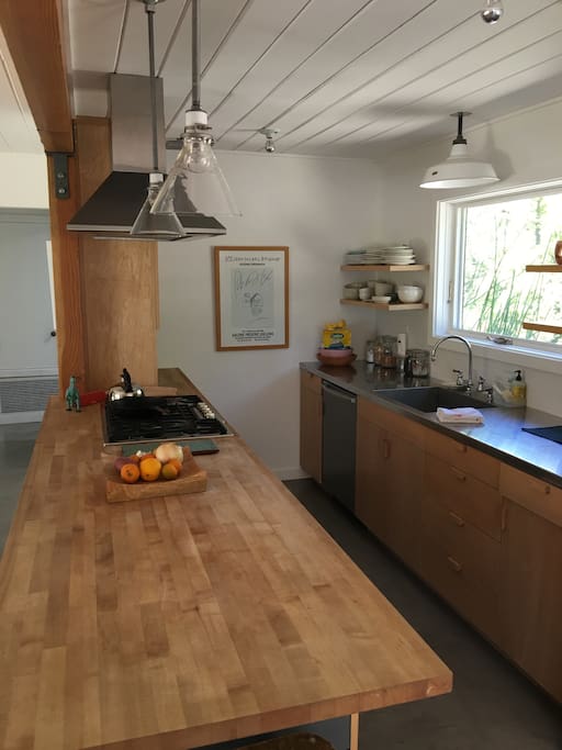 newly remodeled kitchen with butcher block and stainless steel countertops