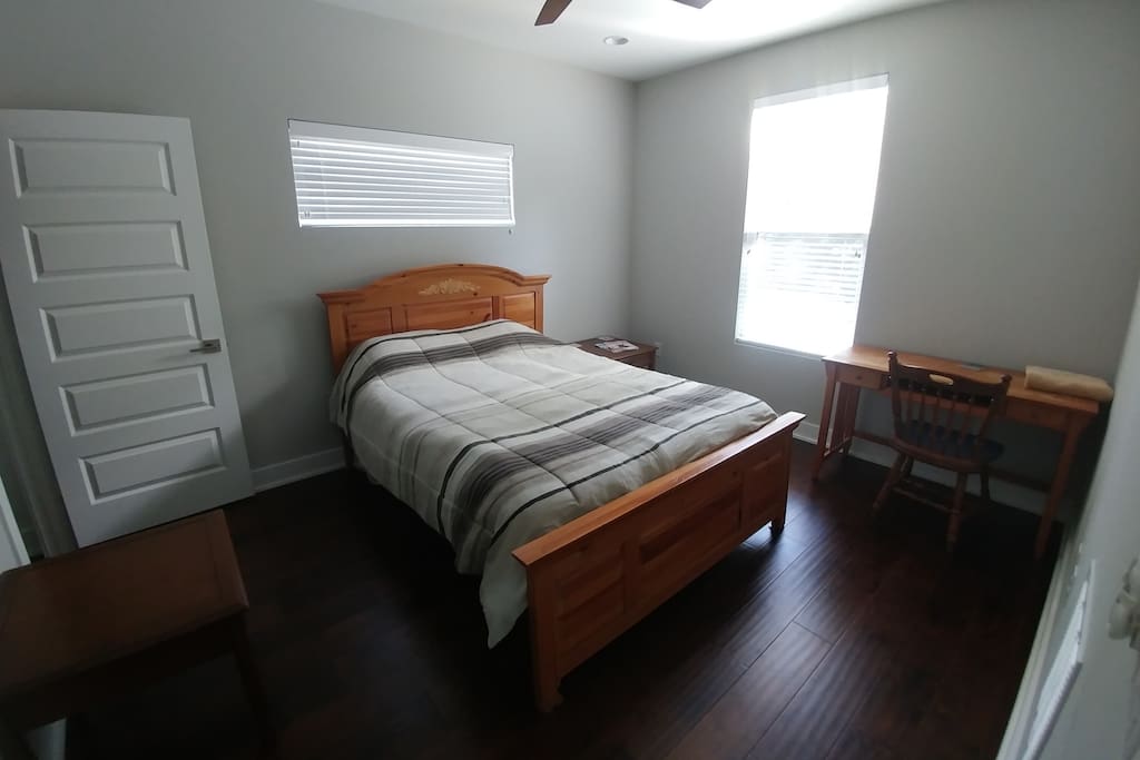 Private bedroom where you will be staying, with a walk-in closet, ceiling fan, and desk.