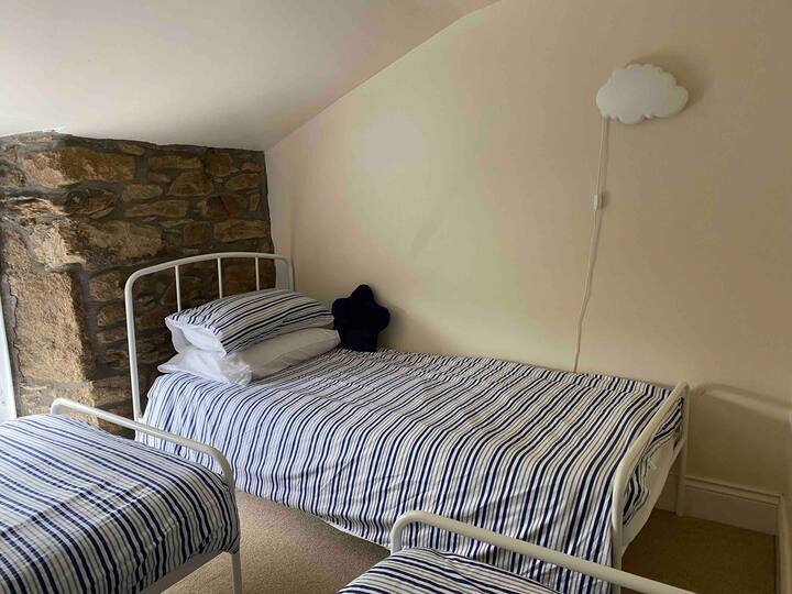 Triple room has 3 single beds, built in wardrobe and garden views.