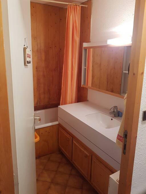 salle de bain avec baignoire et armoire de rangement