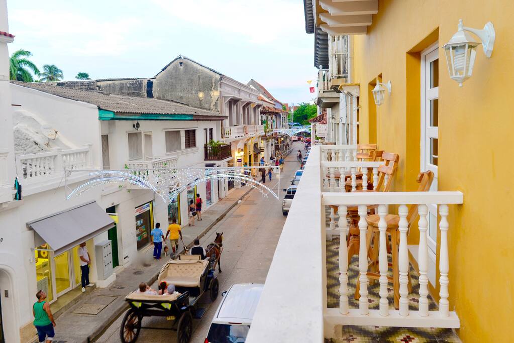 Horse drawn carriages pass right under your balcony