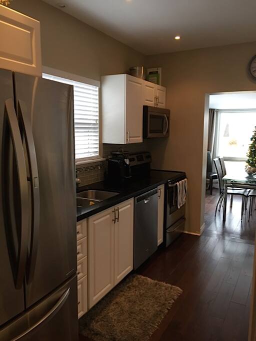 Kitchen with quartz counter top and stainless steel appliances.