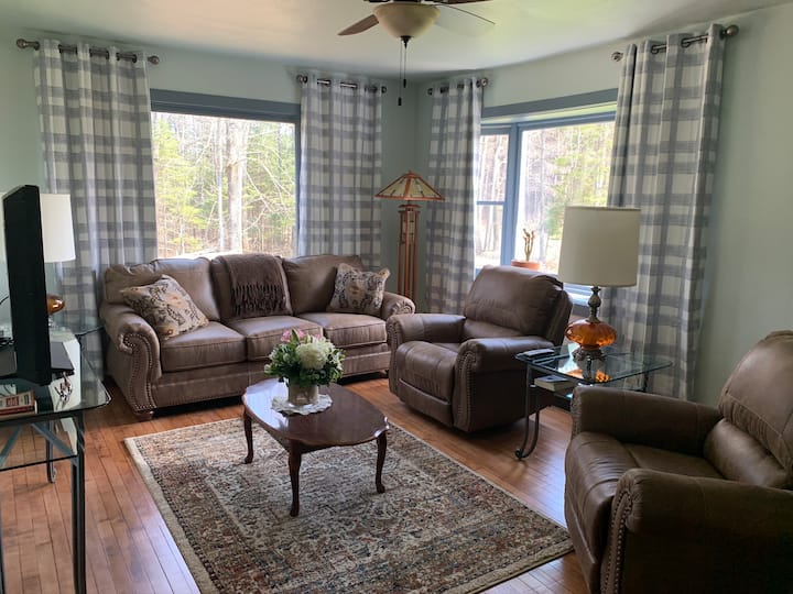 Beautiful living room with authentic hardwood floors.  Comfortable new leather sofa and 2 rocker recliners.  Large TV with cable.  Small library book shelf. DVD player and DVD selection. 