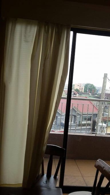 with veranda overlooking the neighborhood from 4th floor