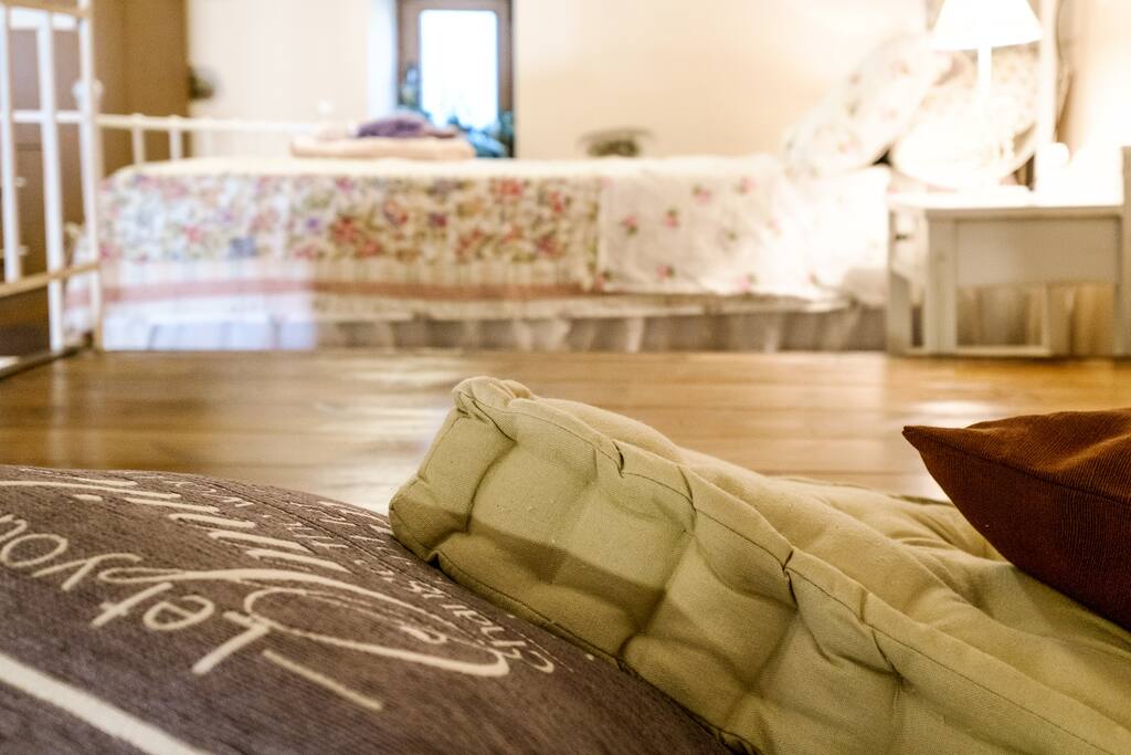 Open space on a wooden floor with cushions. A cozy little nest