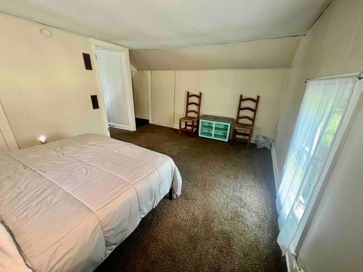 Queen bedroom top of the stairs. Does have a ‘door’ that can close the top of steps. Open floor plan.