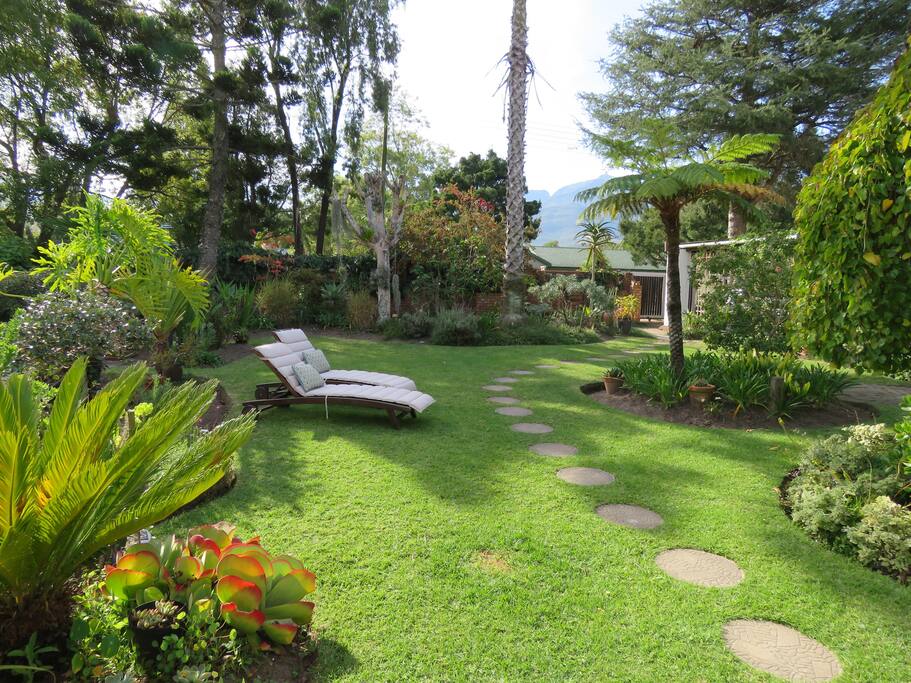 Loungers in picturesque garden setting