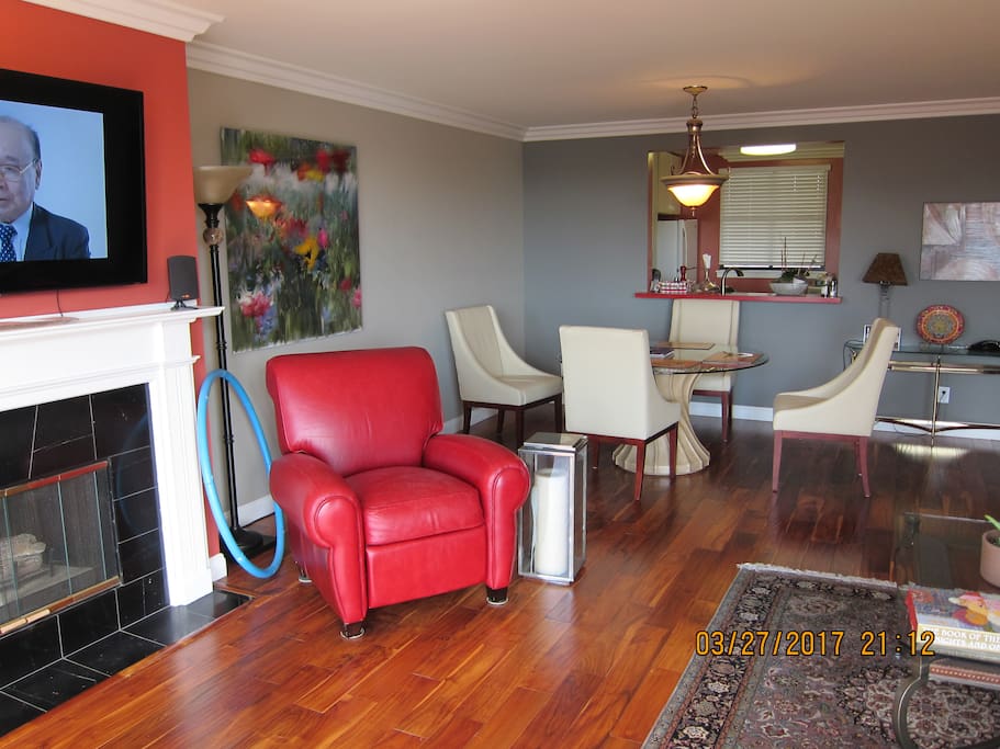 Large living room with beautiful hardwood floors and comfortable reclining chair