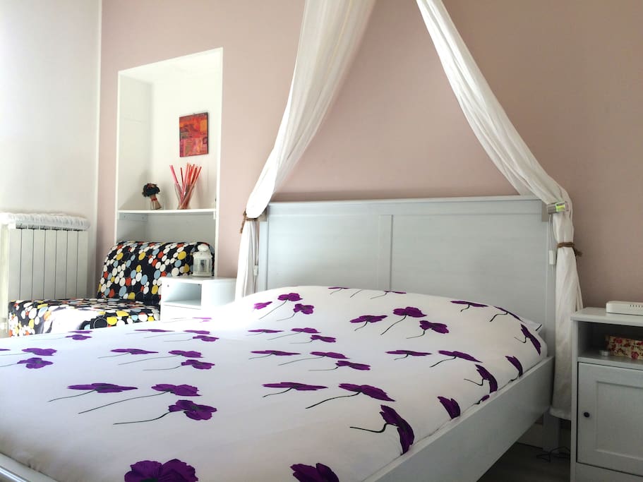 bedroom with double bed and one single bed ( chairbed), balcony