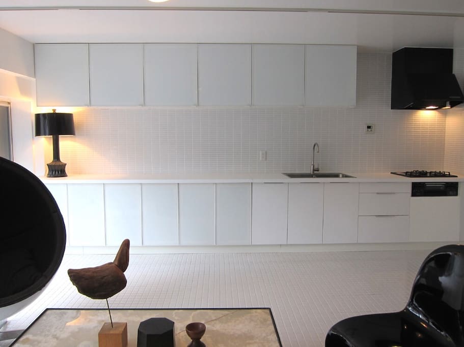 living. Spacious kitchen. Coffee machine to use at the cafe. Total tiled house.