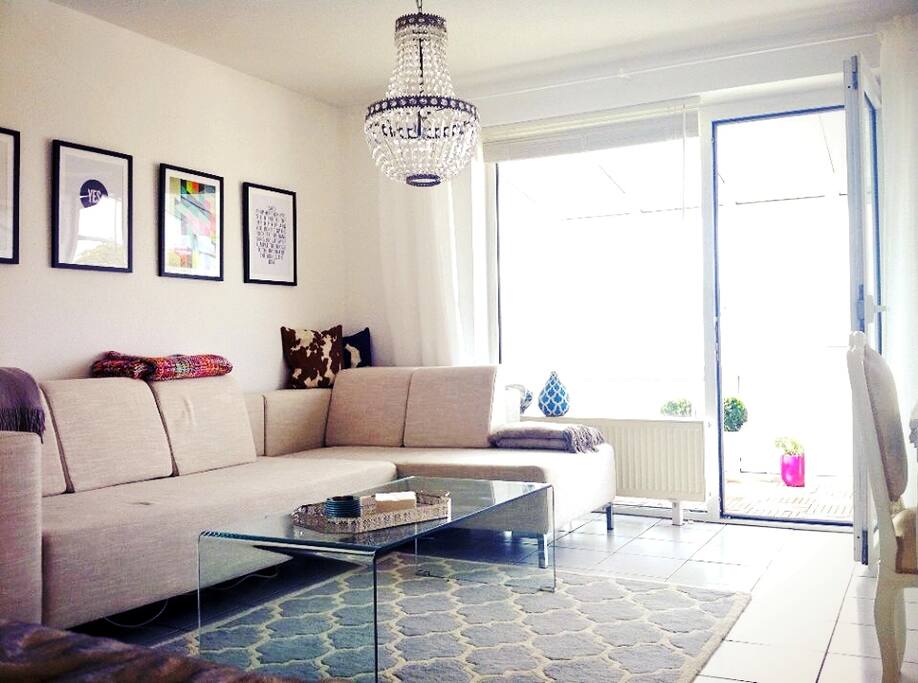 beautiful and light flooded living room with a large sofa landscape and a balcony with skyline view!