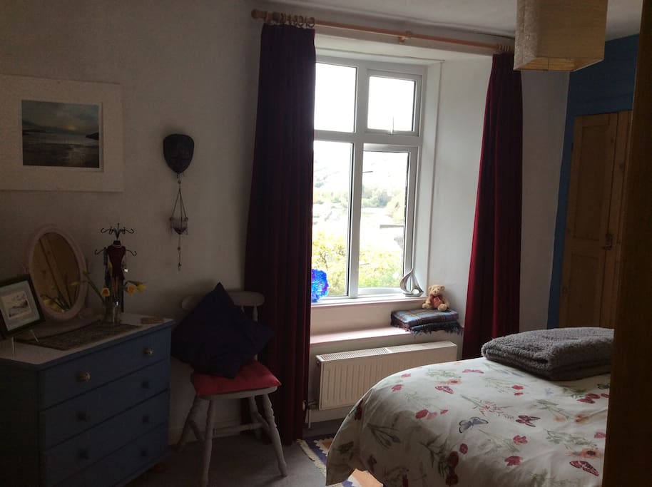 The bedroom looks over the river & woodlands