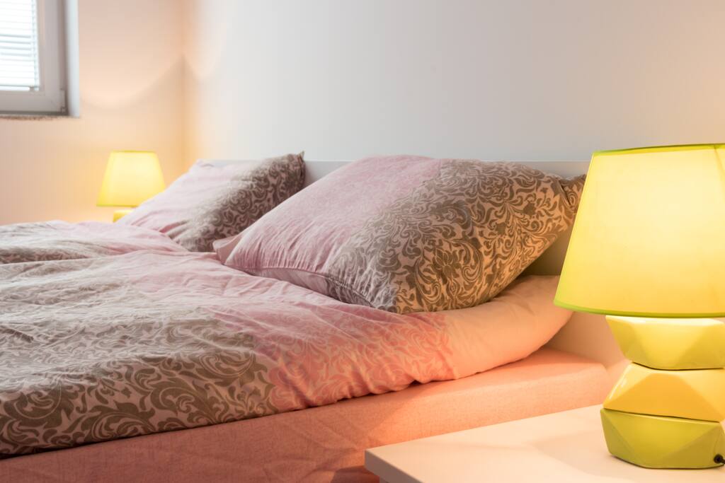Two single beds with bed lamps.
