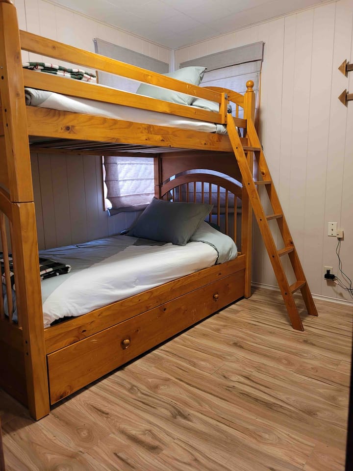 Room #3- Twin size bunk beds with a pullout trundle, includes a dresser, fan, lamp and closet for hanging clothes.