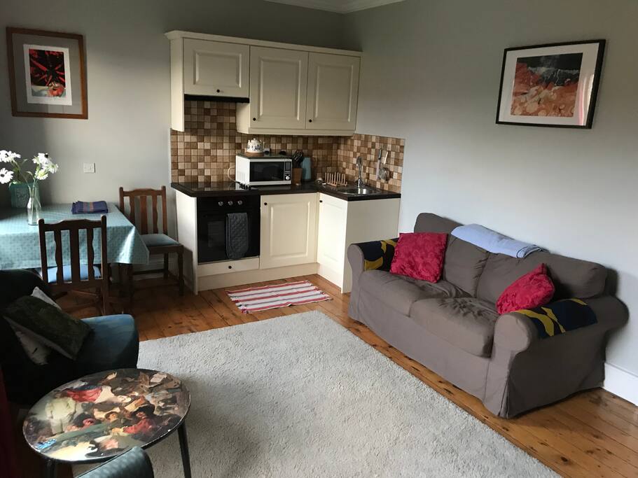 Living room and kitchenette complete with dining table, couch, WiFi, TV etc...