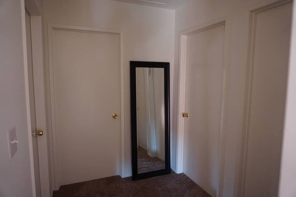 Door to the right is bedroom - door to left of mirror is the bathroom