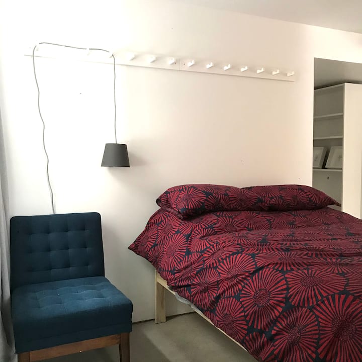 Open bedroom with double bed.