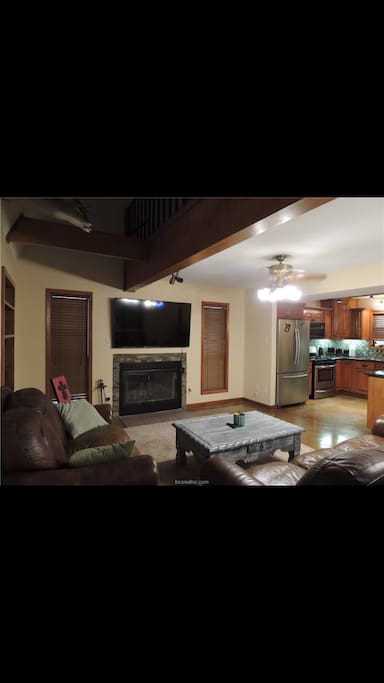 Nice view of a 65” flat screen with two couches.