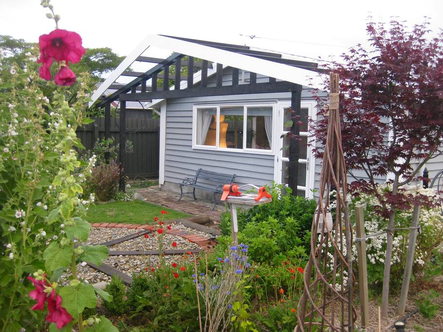 Relax under the pergola. Separate studio space attached to garage.