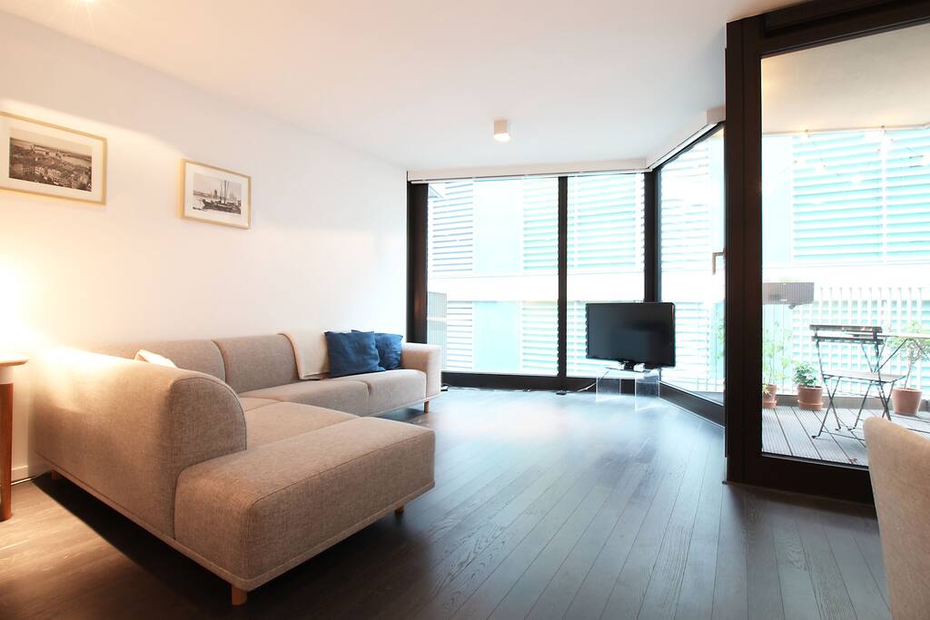 The floor-to-ceiling windows allow the light to flood the room which creates a cozy atmosphere.