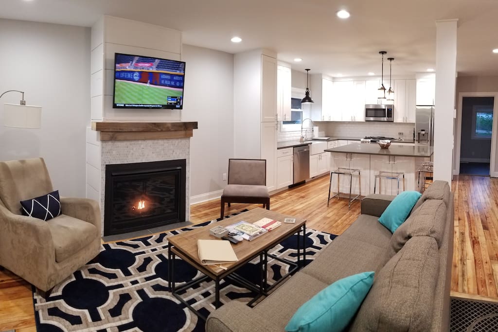 Living room with gas fireplace and fully stocked, brand new kitchen. Flat screen TV with DirecTV and sofa becomes extra queen bed.