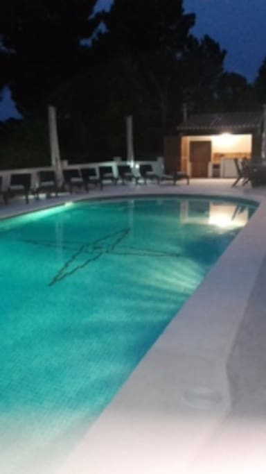 Swimming pool terrace and loungers with poolside bbq